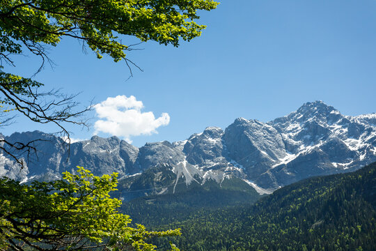 Travel landscape of Zugspitze mountain peak and forest in Alps in Bavaria, Germany, scenic summer nature panorama with forest