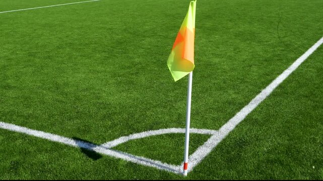 Soccer corner flag beside white field markings