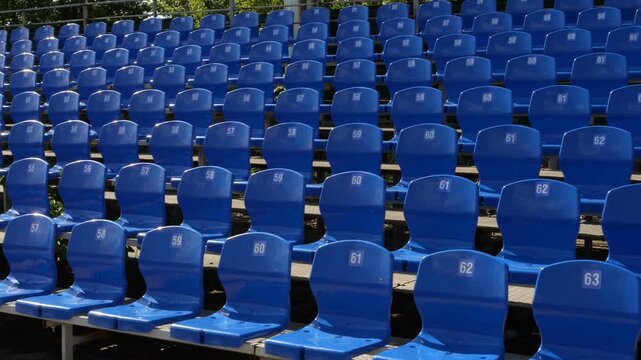 Pattern of empty blue seats in soccer stadium