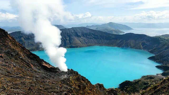 drone shot over taal volcano crater with geothermal steam vent