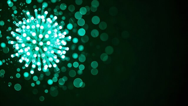 Translucent sphere cluster radiating electric teal light in deep darkness