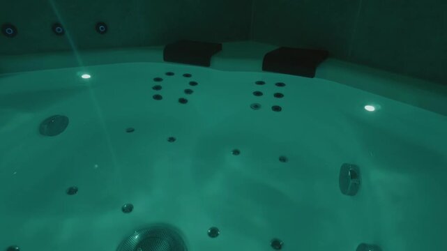 Sparkling water splashes in jacuzzi, pool in golden sunset light, glowing droplets rising 