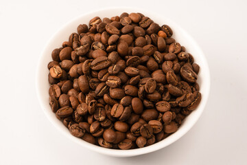 Fototapeta premium Coffee beans on a white background. Top view. Coffee beans texture.