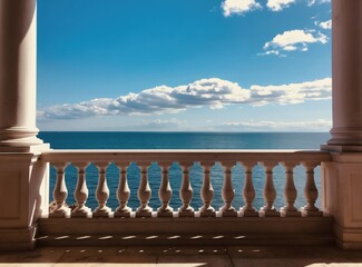 Obraz premium Balcony view of calm blue sea under clear sky with clouds. Ornate balustrade and stone pillars frame ocean horizon. Sunny day vacation mood.