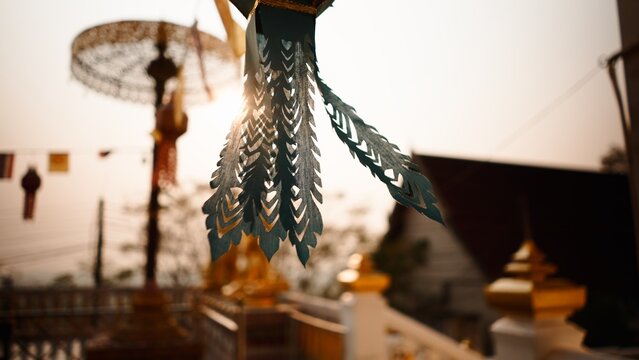 Decorative paper lantern ornament glowing in sunlight at a thai temple