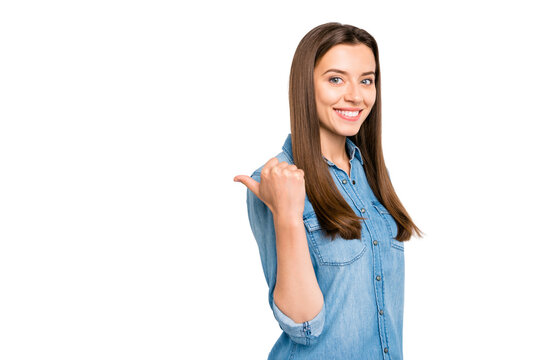 Profile side photo of charming positive confident cool promoter girl point forefinger look indicate sales promo wear denim jeans outfit isolated over white color background