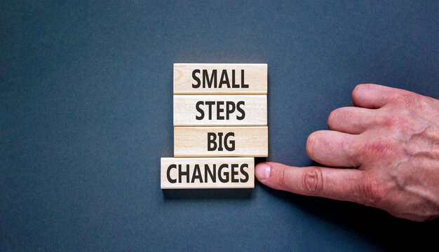 Small steps big changes words symbol. Concept words Small steps big changes on beautiful wooden blocks. Beautiful grey background. Business motivational small steps big changes concept. Copy space.