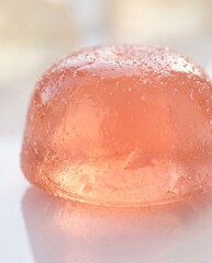 Fototapeta premium Translucent peach collagen gummy macro close up ingestible beauty supplement