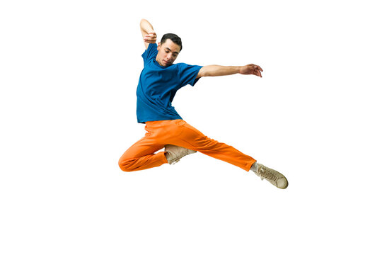 Male dancer jumping mid-air, performing an acrobatic split on a white background, demonstrating agility and flexibility