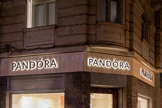 Famous Pandora jewellery store logos on building facade glowing at night in city street in Belgrade capital of Serbia