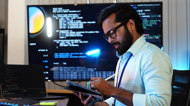 Developer analysis AI coding algorithm on tablet and computer screen. Professional software engineer review program script data at workplace. Tech expert optimize deep learning network