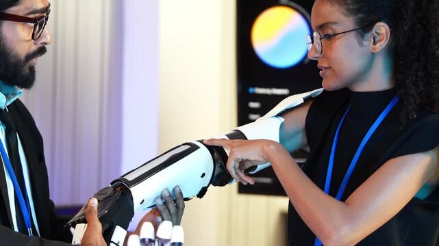 Tech expert evaluate robot arm and artificial prosthesis limb function. Engineer check bionic mechanic device with female user. Developer examine cybernetic system during laboratory experiment