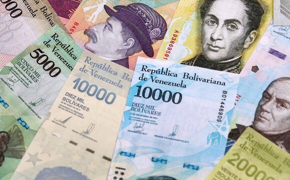 Venezuelan bolivar money bills pile on table. Venezuela banknotes of VES currency close up.