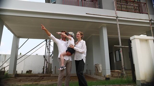 New house, caucasian family father, mother, and daughter look at their house that is under construction. They are imagining how they will live happily in this house (1)