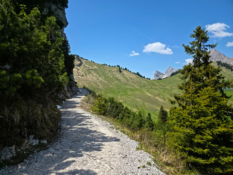Austria, Peaceful alpine trail beside snow and dramatic rocks showcasing unforgettable mountain wilderness beauty on hahnenkamm