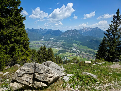 Austria, Perfect framed view toward Reutte valley between conifers with alpine peaks and endless skies on hahnenkamm mountain