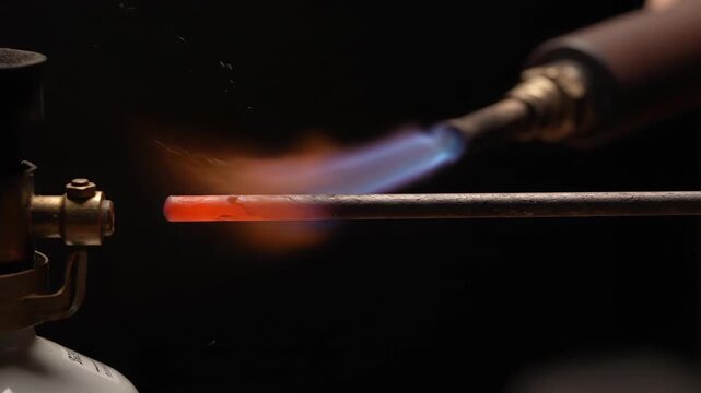Flame heating metal rod scene, close-up of the flame of the flamethrower