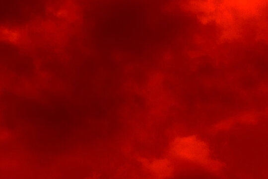 Red cloud texture background. Blurred photo of red sky with clouds. Photo can be used for galaxy space, New Year, Christmas and all celebrations backgrounds.
