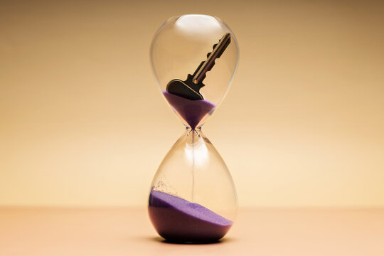 Key inside hourglass, limited time, life opportunities and time management