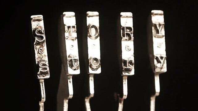 The word STORY with vintage typewriter hammers isolated on black 