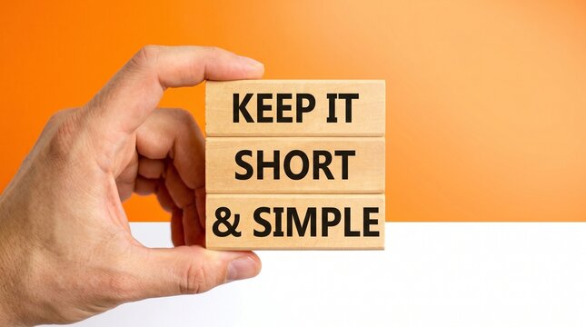 Hand holding wooden blocks with the message 'Keep it short and simple'