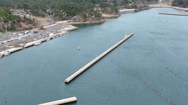 Aerial View of Long Breakwater and Blue Sea at Ayukawa, Oshika Peninsula, Japan