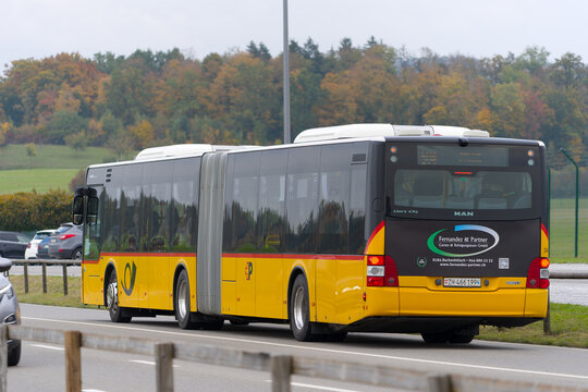 Yellow Swiss Post Bus number 504 Destination B&uuml;lach railway station passing at Pistenende at Swiss village of Oberglatt on an autumn day. Photo taken October 17th, 2025, Zurich Oberglatt, Switzerland.