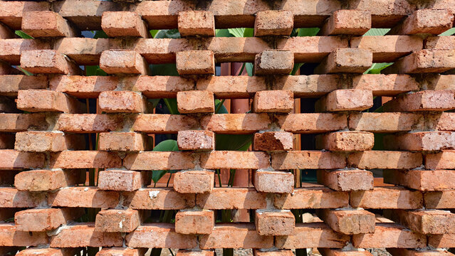 brick jaali wall, a type of porous architectural screen.Architectural background texture: A modern, openwork brick screen wall (Jali or perforated brick wall)