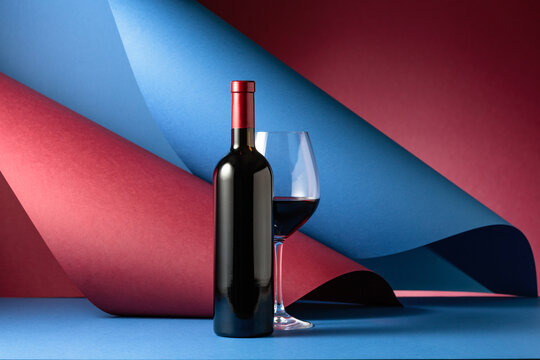 Bottle and glass of red wine.