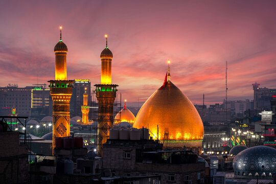 Karbala, Iraq - December 28, 2025: Golden dome and illuminated minarets of the Imam Hussain Shrine glowing at dusk in Karbala, Iraq