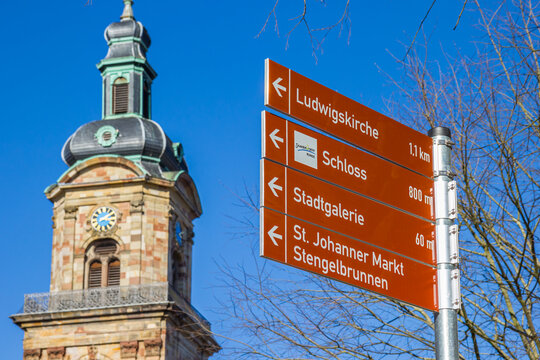 Tourist sign near the tower of Basilica of St. John in Saarbrucken