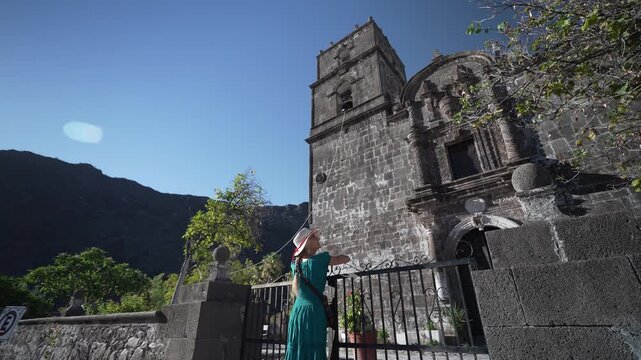 Excited senior woman smiles as she explores San Javier Mission near Loreto in Baja California Sur Mexico during beautiful sunrise
