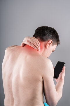 Man with neck pain from using smartphone, text neck and bad posture concept