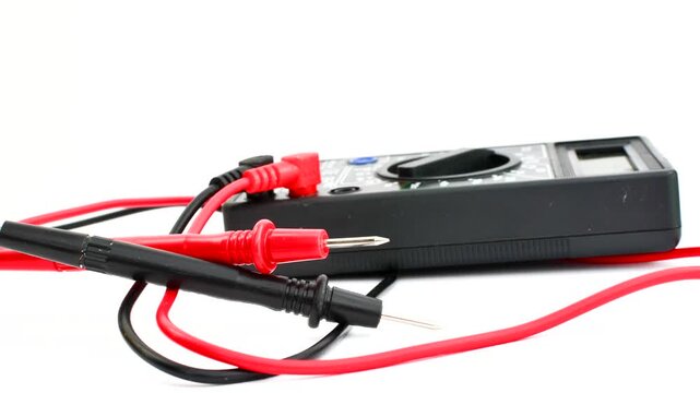 Close-up of a multimeter on a clear surface, highlighting precision and versatility for electrical measurements.