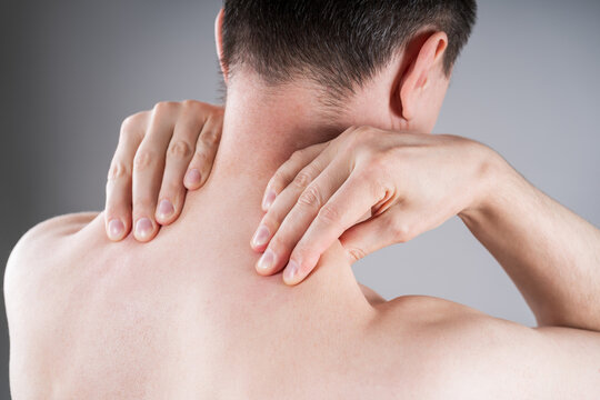 Man suffering from neck and shoulder pain. Massaging tense trapezius muscle. Office syndrome and backache medical concept