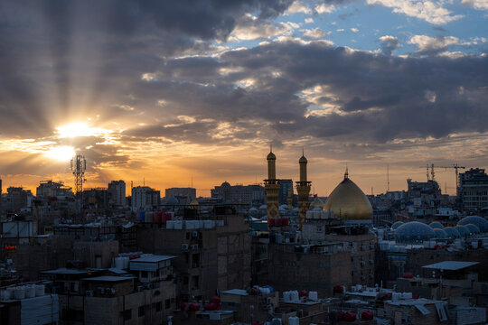 Karbala, Iraq - December 28, 2025: Golden dome and illuminated minarets of the Imam Hussain Shrine glowing at dusk in Karbala, Iraq