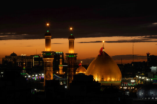 Karbala, Iraq - December 28, 2025: Golden dome and illuminated minarets of the Imam Hussain Shrine glowing at dusk in Karbala, Iraq