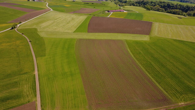 Aerial drone view of farmland fields and rural landscape in spring