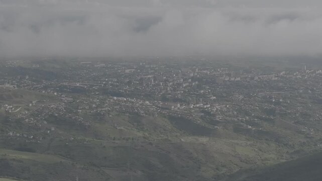 Aerial drone view of Shusha city covered with mist and clouds in the mountains, Azerbaijan