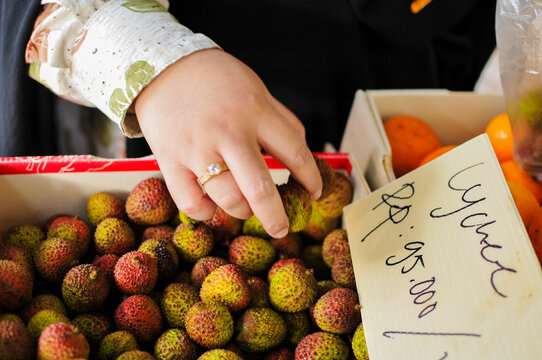 fresh lychee fruits being sorted for sale