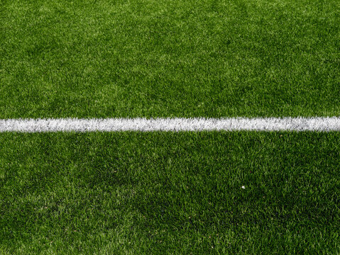 White sideline on dark green soccer pitch