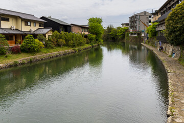 Fototapeta premium katsura river flowing through traditional kyoto neighborhood