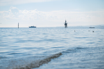 Fototapeta premium Lake constance water with distant boats, buoys, and ducks