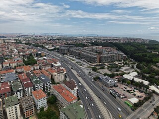 Obraz premium Panoramic Aerial Cityscape Under a Dramatic Cloudy Sky