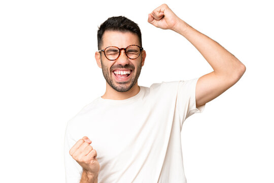Young handsome caucasian man over isolated chroma key background celebrating a victory