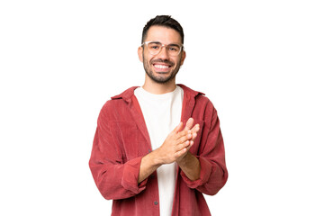 Young handsome caucasian man over isolated chroma key background applauding after presentation in a...