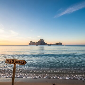 Wooden Isla De Tabarca Sign Facing Calm Sea and Rocky Island at Sunset