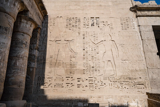 The art  of ancient Egyptian story telling with carvings, reliefs and Hieroglyphs, Medinet Habu, the ancient Egyptian Mortuary Temple of Ramesses III on the West Bank of The Nile, Luxor, Egypt.