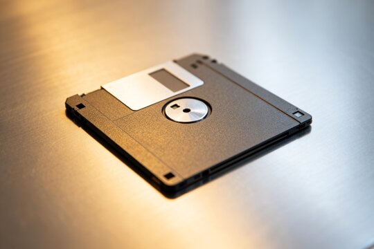 Old floppy disk on metallic surface