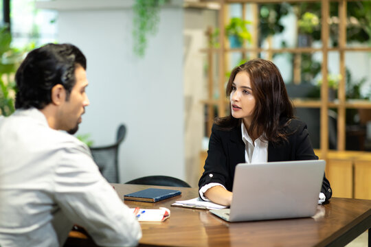 Happy young beautiful woman working and talking with customer at home office. saleswomen and businesswoman concept.